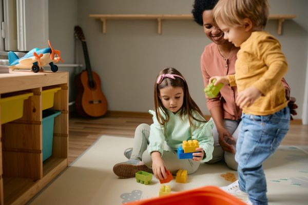 small-kids-and-their-african-american-nanny-playing-with-toy-blocks-.jpg